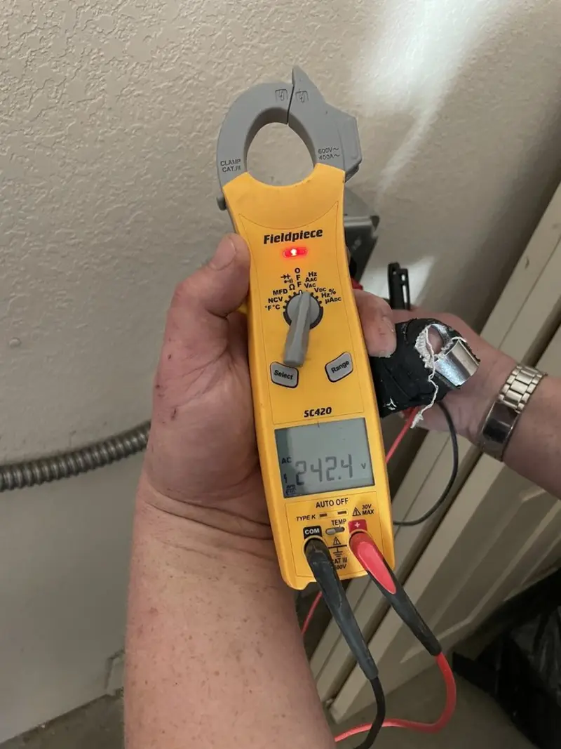 Voltage testing with clamp meter during Outlet Installation in South Burlington
